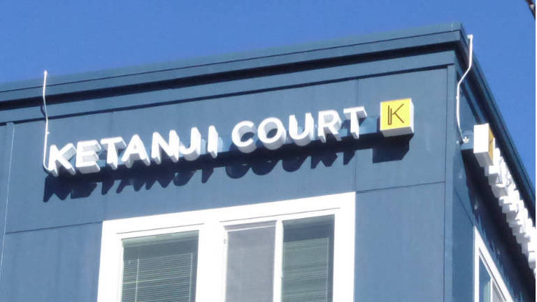 The Ketanji Court sign at the upper edge of the building