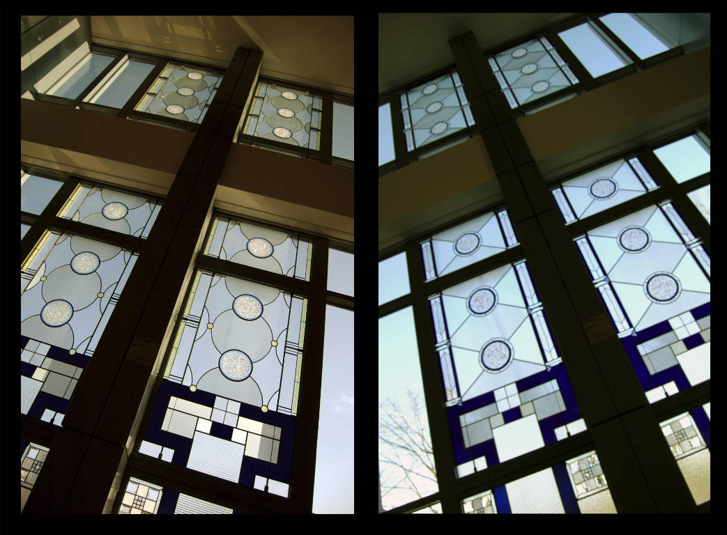 Two windows, one featuring central round shapes and one featuring central diamond shapes, each two stories tall